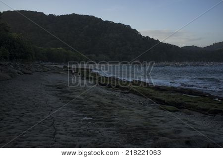 INDONESIA: Scenery of Tanjung Papuma Beach with rock and mossy foreground. Papuma beach is located at Jember,Surabaya, East Java.