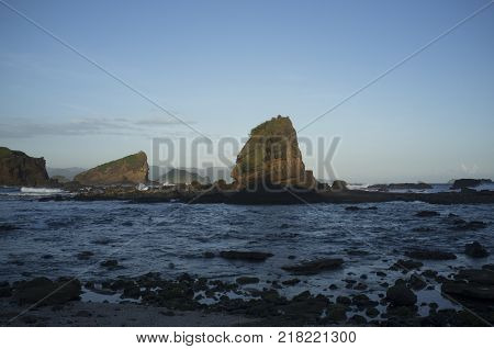 INDONESIA: Scenery of Tanjung Papuma Beach with rock and mossy foreground. Papuma beach is located at Jember,Surabaya, East Java.