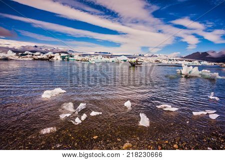 Picturesque striped Cirrocumulus clouds over Ice lagoon Jokulsarlon, Iceland. The concept of northern extreme tourism