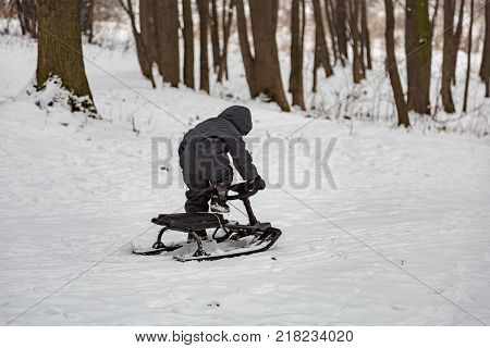 Boy And Snow Racer In Winter