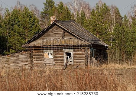Wooden abandoned old house with the driven-in windows in Preobrazhenskoe. Tyumen region. Russia