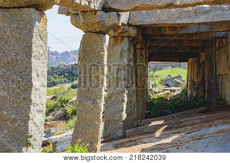 View of ancient ruins on Hemakuta hill in Hampi, Karnataka, India. Landscape with unique mountain formation with amazing stones, tropical nature and temple. UNESCO World Heritage Site