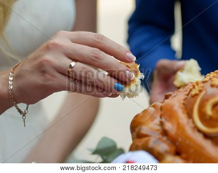 Close up hands holding piece of weding bread Russian tradition