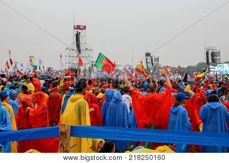 A crowd of people dressed in raincoats with flags World Youth Day Krakow Poland 2016