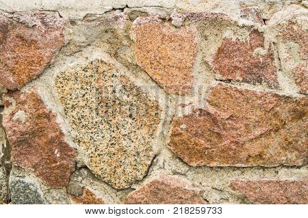 background stone walls of pink granite, texture