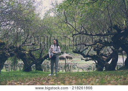 Tourist Use Smart Phone To Take Selfie Picture In Apricot Tree Orchard. People, Travel, Nature Conce