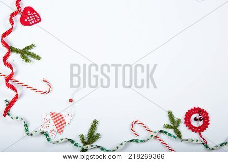 Christmas holiday composition. Festive creative red pattern, xmas handmade decor holiday with ribbon, candy canes, gift, christmas tree and decorations on white background. Flat lay, top view