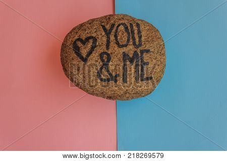 the english  writing you and me with a heart drawn on a stone/the writing you and me with a heart drawn on a stoneindicates the love promise of two lovers