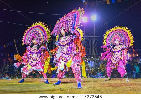 BAMNIA PURULIA WEST BENGAL INDIA - DECEMBER 23RD 2015 : Four dancers performing at Chhau Dance festival. It is a very popular Indian tribal martial dance performed at night amongst spectators.