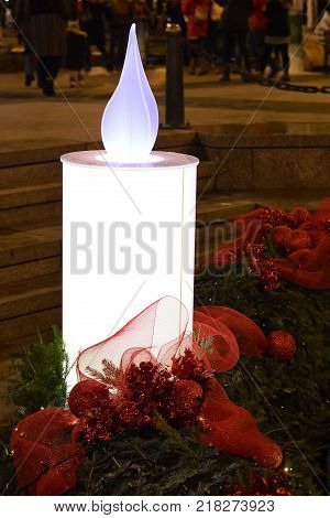 Burning Advent candle at Mandusevac fountain in Zagreb, Croatia