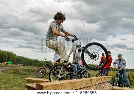 Tyumen, Russia - September 16, 2007: Second festival of cyclists Samogon in Silkin Log. Cyclists jump through a log as a sports stage