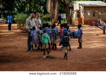 KOLONYI, UGANDA - OCTOBER 30, 2017: German doctors meeting a group of Uganda children. Doctors preparing to help the local hospital.