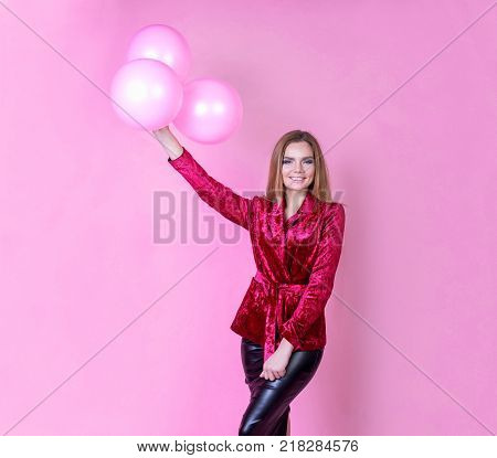 beautiful girl with balls on a bright background a party