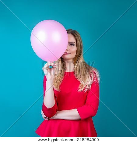 beautiful girl with balls on a bright background a party