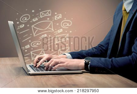 An office worker sending emails and communication with clients with the help of a portable laptop on desk concept