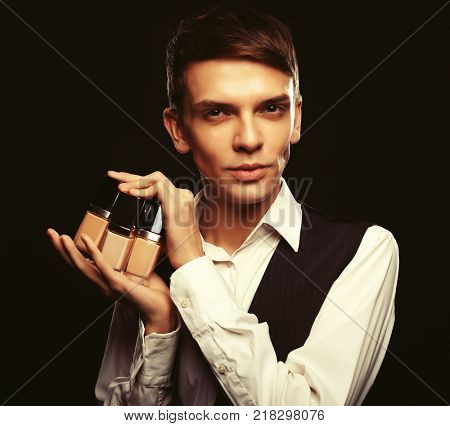  Young male make up artist posing  with foundation for make-up o