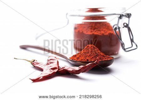 Red Chilly Powder in a bowl with dried red chillies over colourful background or pile of red chilli powder over plain background