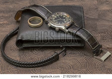a business man leather accessory, closeup. Wallet, strap, handstrap and mobile phone with case.