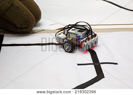 MOSCOW/ RUSSIA - DECEMBER 13, 2017. Schoolboy testing the robot at robotics competitions.
