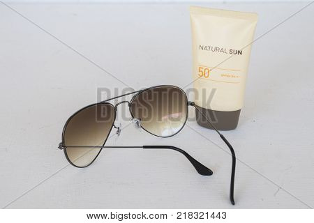 natural sun cosmetics for skin face sunscreen spf50 and accessories of woman on white