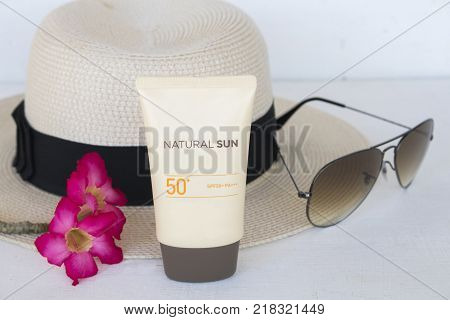 natural sun cosmetics for skin face sunscreen spf50 and accessories of woman on white