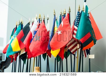 Flags from multiple nations and countries on a shelf showing concepts of international and global.