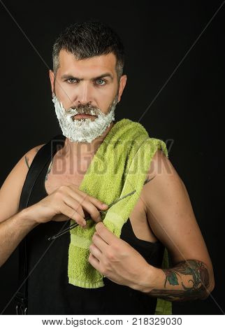 Haircut of bearded man archaism. Serious hipster in barbershop new technology. Man cut beard and mustache with razor and shaving gel. Barber and hairdresser. Fashion and beauty innovation.