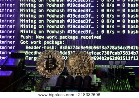 The digital process of cryptocurrency mining by using the GPUs. Bitcoins and video card on a working display and mining screen