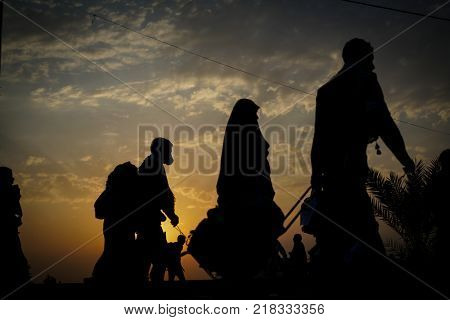 Silhouettes of people walking