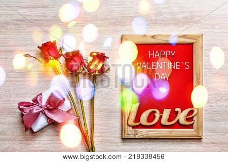 Valentine's Day. Happy Valentine's Day card, gift box and red rose on wood background, banner. top veiw