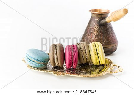 French Colorful Macarons with Pots on a White Background
