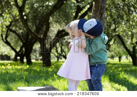 Children Kiss in the Park. Lover Concept
