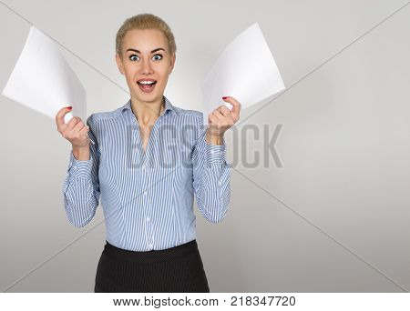 Young Business Woman with Documents in Hand Rejoices. Copy Space
