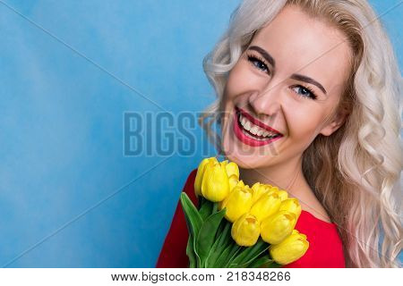 Bright Young Blonde Woman with a Bouquet of Flowers. Copy Space. Spring Concept