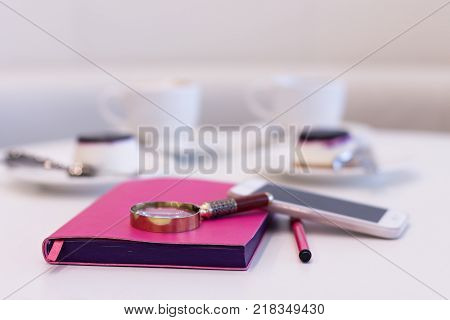 Still lLife from a Notebook on the Background of Coffee with Dessert