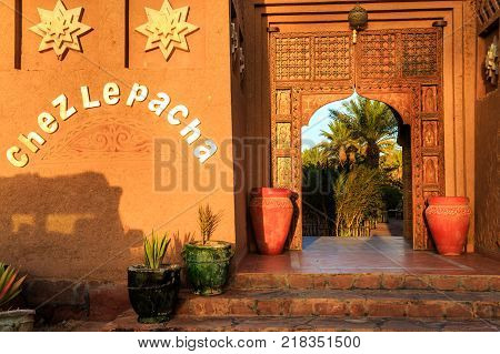 M'hamid Morocco - February 22 2016: typical arabic style front door outside view of Chez le Pacha hotel outside view with blue sky