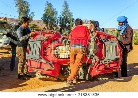Ait Saoun Morocco - February 23 2016: Group of mechanic and traveller repairing atv RZR800 at garage near Ait Saoun dessert in Morocco