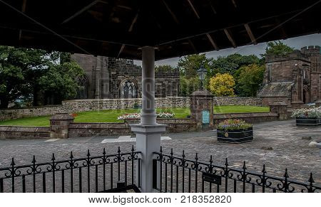 Looking from under the canopy of the well towards the market square in Standish in Wigan