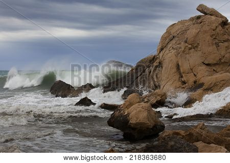 photo of a storm in the sea in the rocks