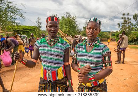 TURMI, OMO VALLEY, ETHIOPIA - MAY 5, 2015: Two girls from the Hamar tribe with traditional jewelry at a popular local market.