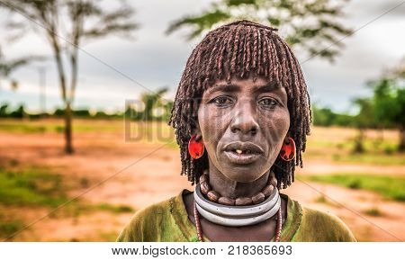 TURMI, OMO VALLEY, ETHIOPIA - MAY 5, 2015: Woman from the Hamar tribe at a local market in south Ethiopia.