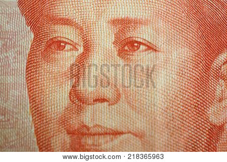 Macro detail of a Chinese one hundred rmb note bill showing the face portrait of Mao Zedong