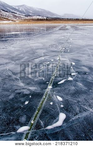 Frozen Lake Baikal. Beautiful mountain near the ice surface on a frosty day. Natural background. Russia. Siberia