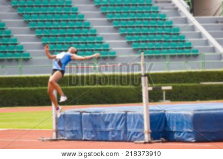 Blurred - Woman athlete is training in action of high jumper at stadium