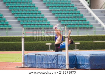 Blurred - Woman athlete is training in action of high jumper at stadium