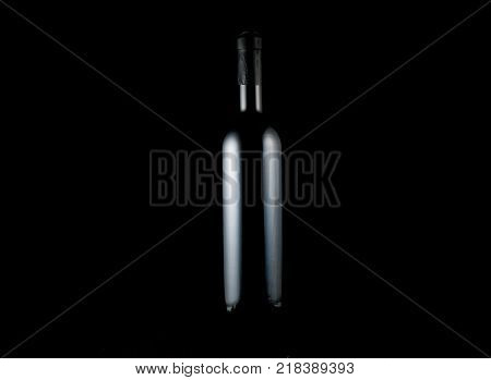 Bottle of red wine isolated on black background