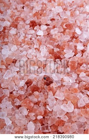 Himalayan pink rose colored natural salt. Himalayan salt crystals texture pattern as background. Healthy salt from Himalayas. Pink rose ealt.