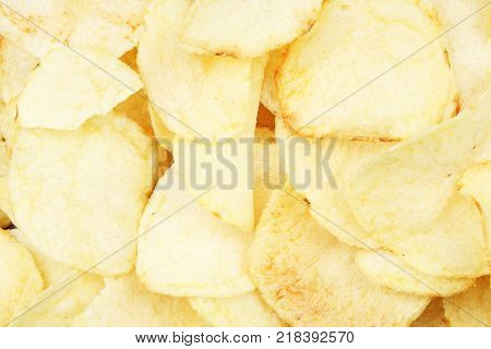Chips pattern. Yellow salted potato chips as background. Chips texture studio photo. Food.