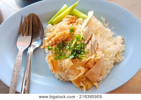 Seletive focus on vegetable of Thai traditional food (Khao-Mun-Kai). Chicken rice with Chicken fried crispy.