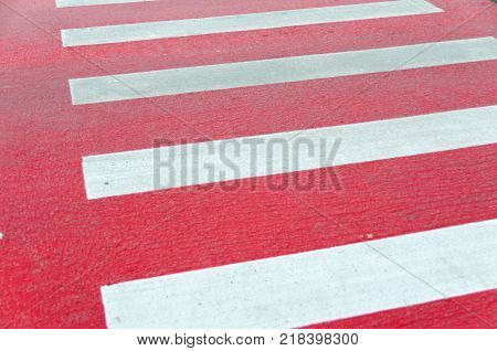 Red painted pedestrian crossing close up shot
